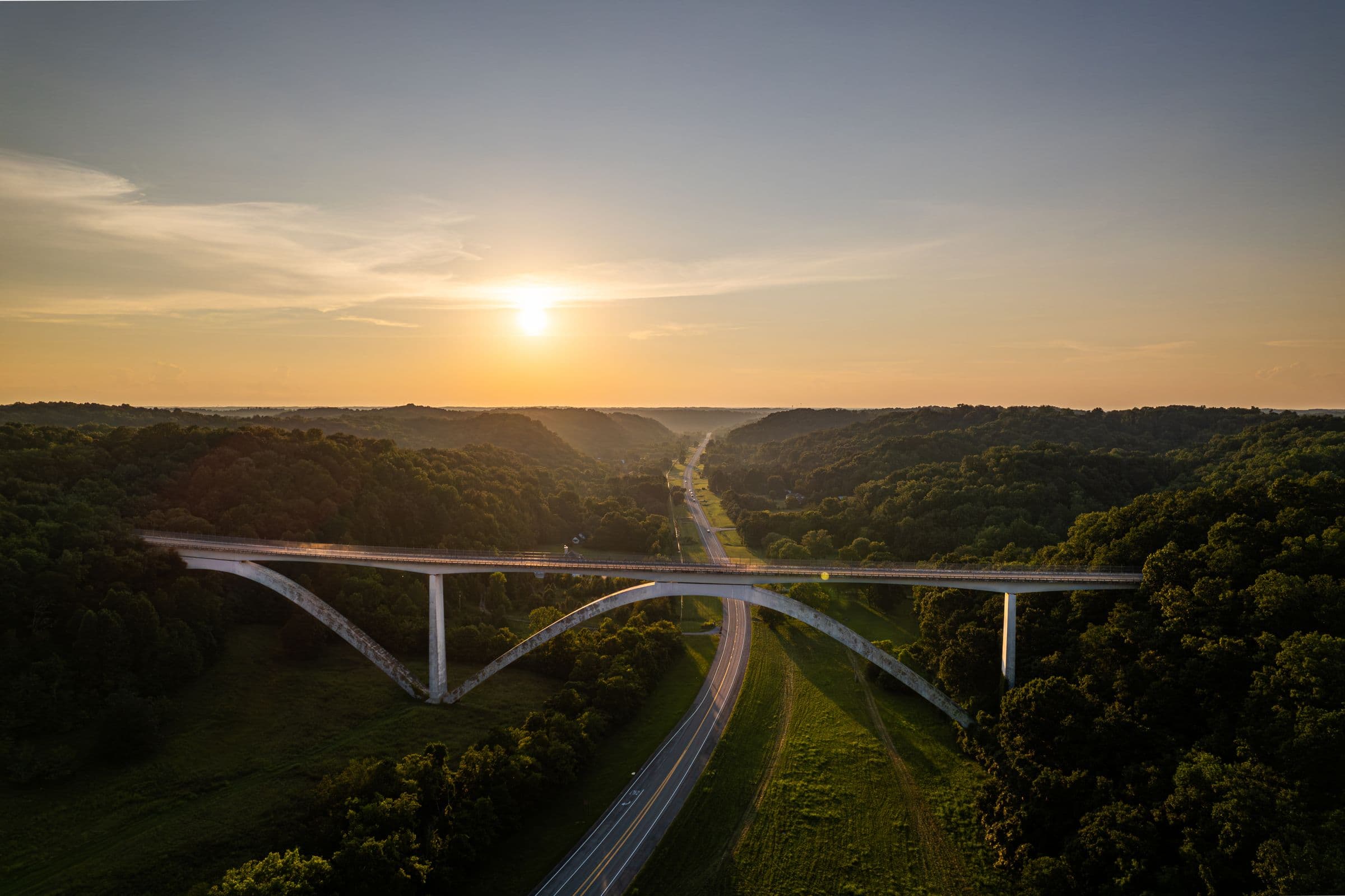 The Natchez Trace Parkway Bridge at sunset over the Tennessee hills